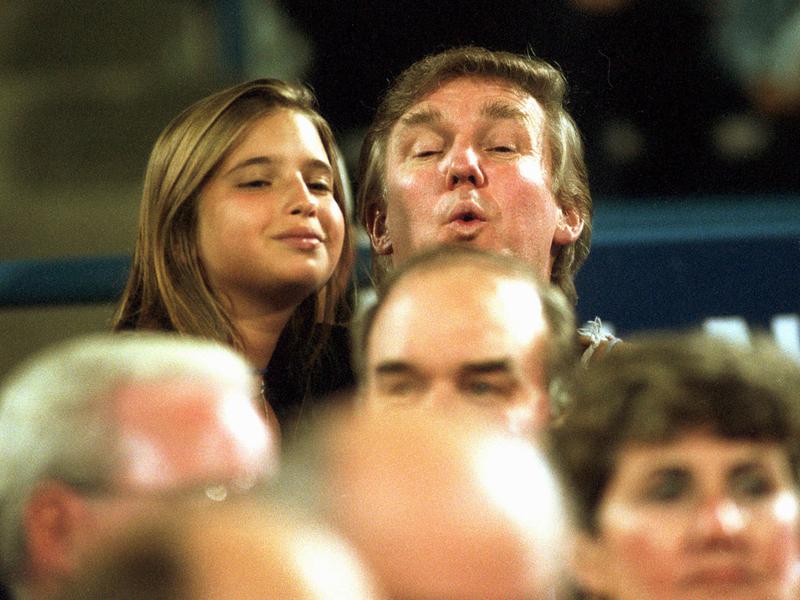 Donald Trump and his daughter Ivanka peek over the crowd as they take in a tennis match during the 1994 U.S. Open in New York.