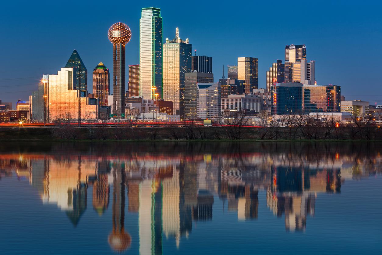 Dallas skyline at sunset reflected in the flooded Trinity River